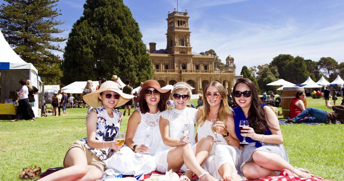 Five girls having a picnic in front of Werribee Mansion
