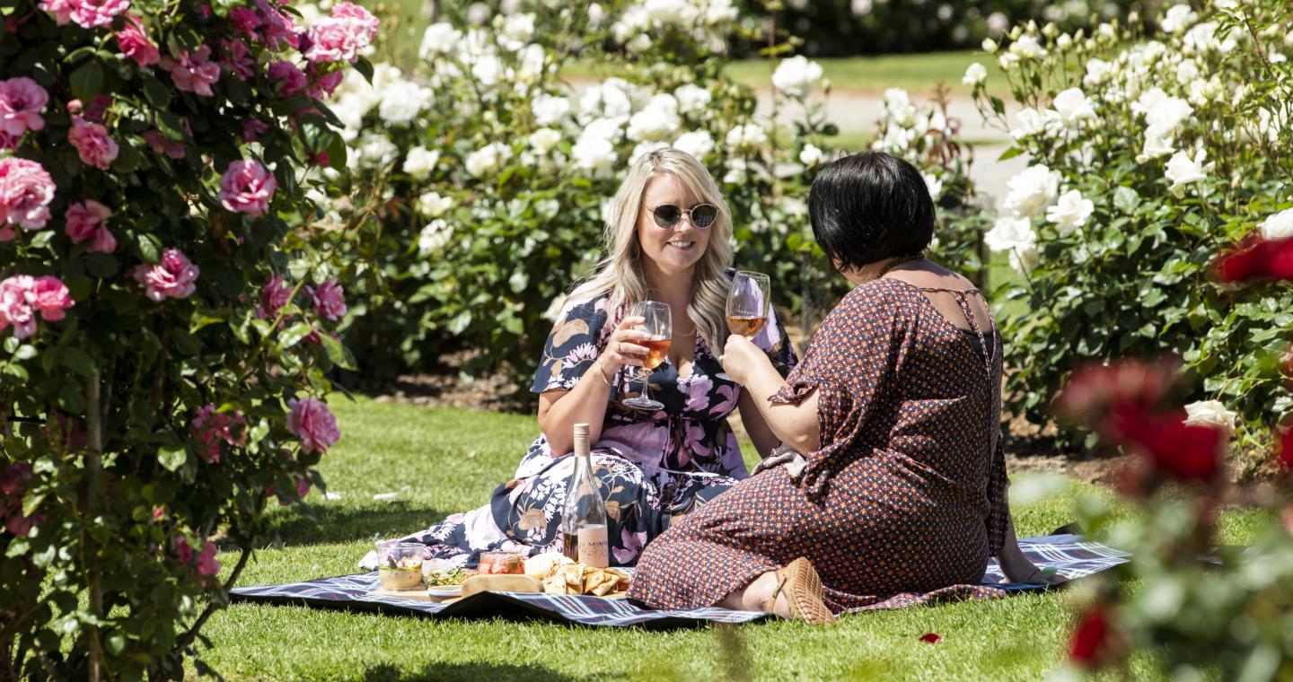 Two ladies picnicing at the Victoria State Rose Garden