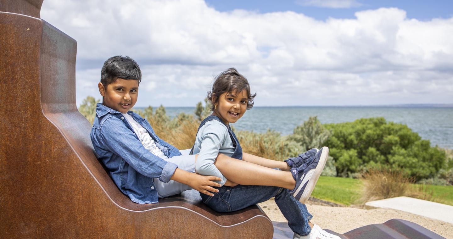 children on sculpture