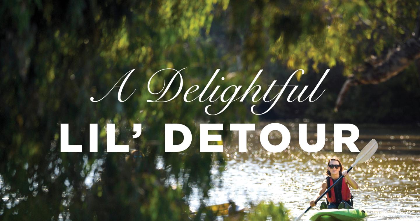 a woman kayaking on a river with trees and text A Delightful Lil' Detour