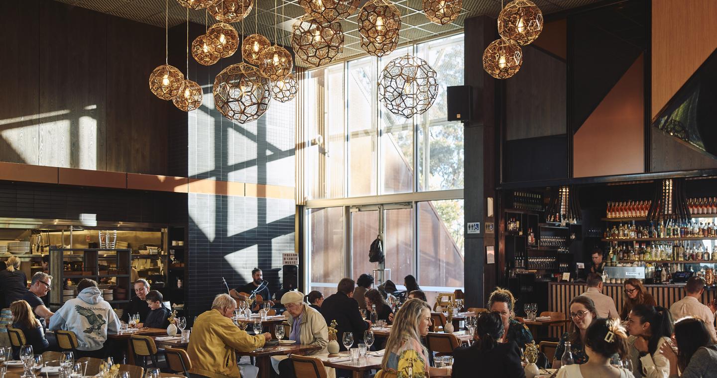 long table of people dining inside Shadowfax Winery