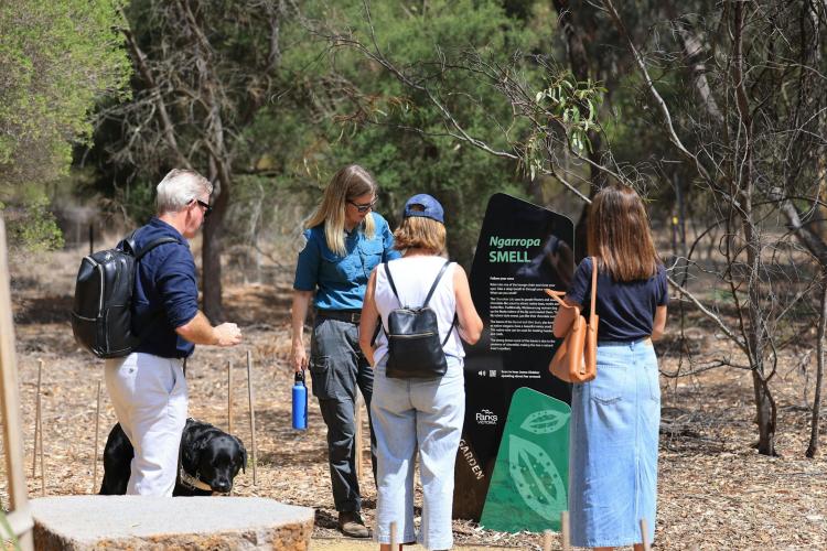 Visitors enjoying the garden with a park ranger