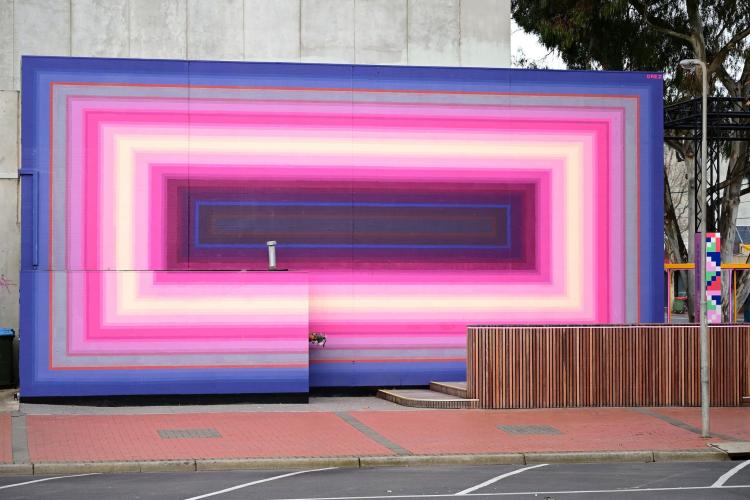 A large abstract mural made up of rectangles in pinks and purples