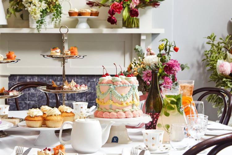 High tea spread set up of cakes, treats and tea