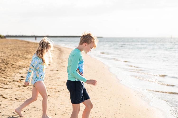 two children walking into water at Werribee South Beach