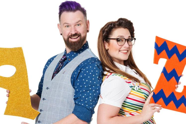 Man holding alphabet A and woman holding alphabet Z