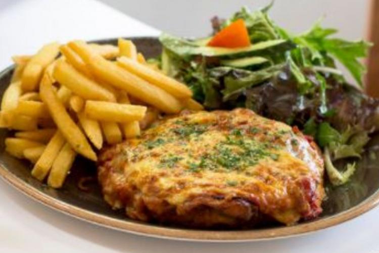 plate of parma with chips and salad