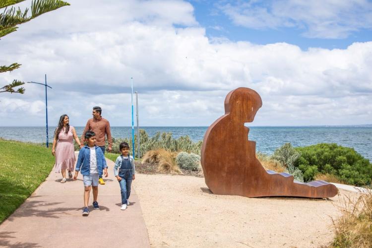Family walking beside sculpture at Werribee South Foreshore