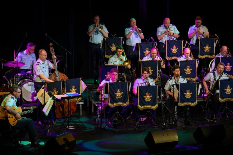 multiple people  on stage playing musical instruments