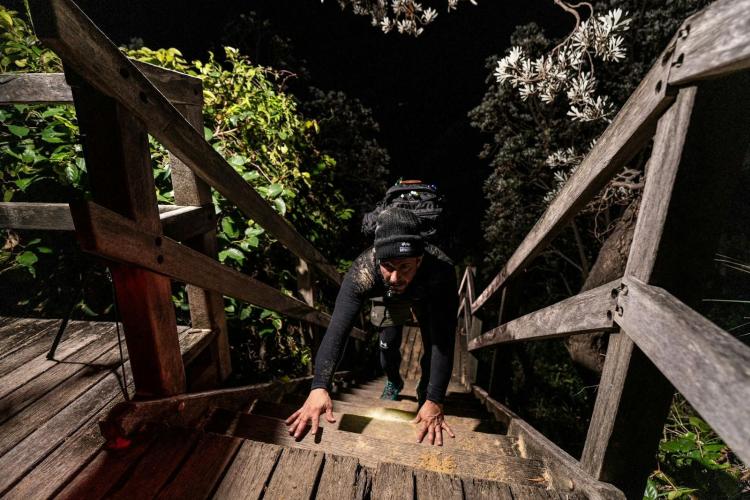 A person scales a wooden staircase.