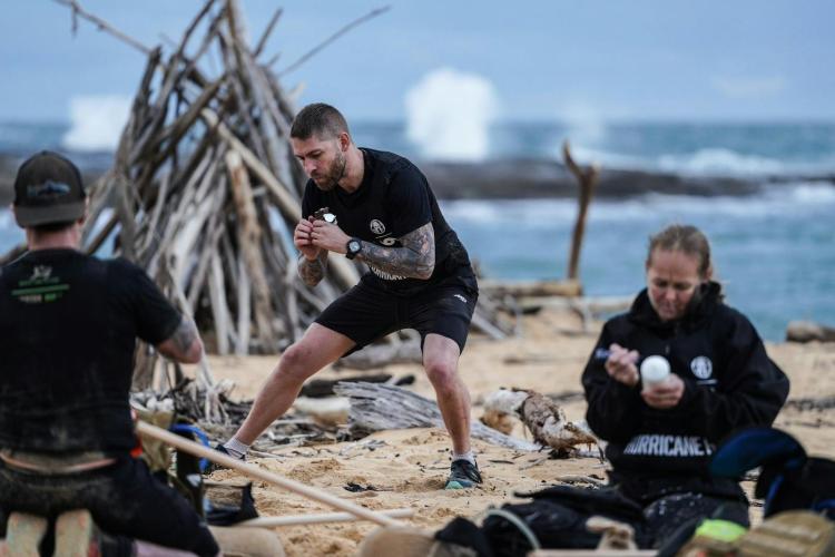 A group of competitors solve puzzles together.