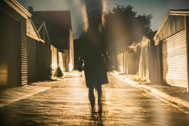 Lone figure walking in the dark