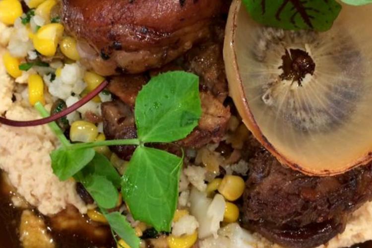 spiced lamb shoulder with sweet corn, raisin, cauliflower cous cous, hummus