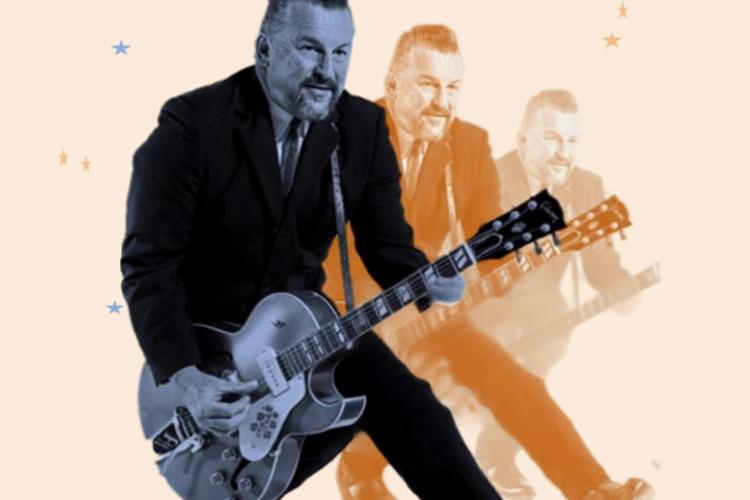 Man in dark suit playing a guitar