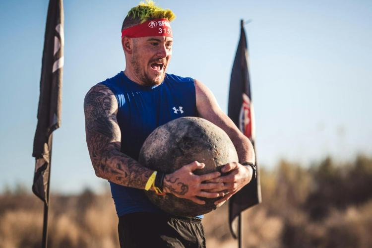 A person competes in Spartan Race.