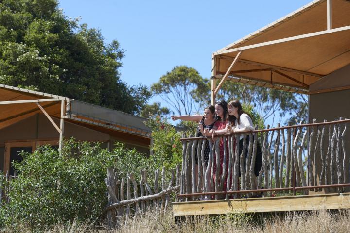 Girls looking of the balcony of  Slumber Safari Accommodation