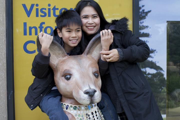 Mother and son on statue of kangaroo