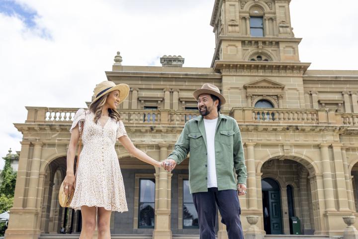 couple in front of mansion