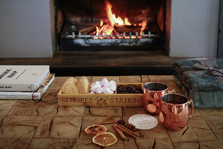ingredients for making smores in front of an open fire